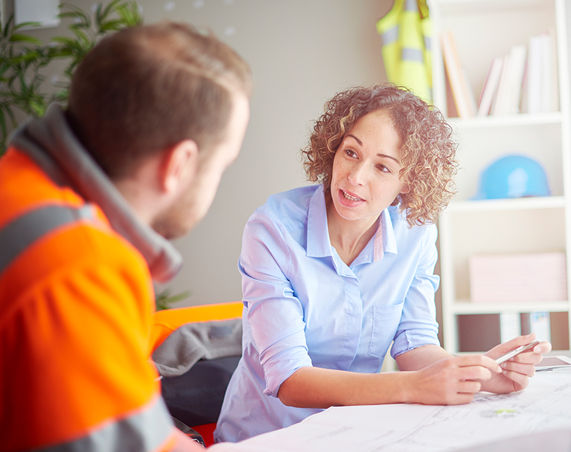Two people talking at table EAP