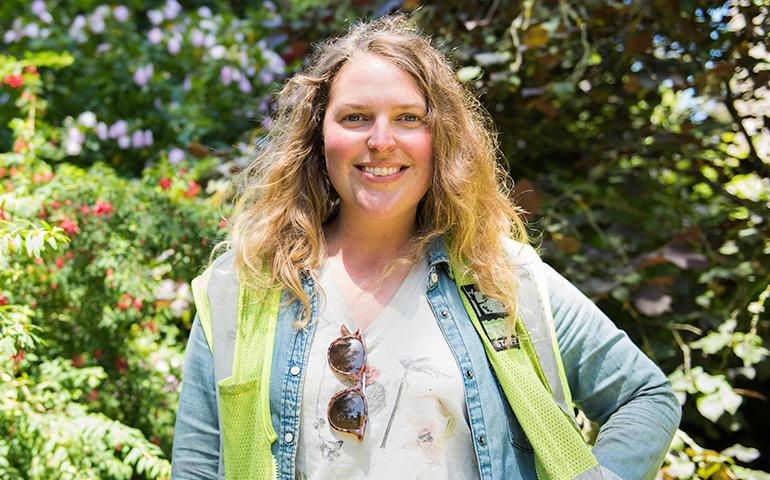 Image of female gardener from the Recreation and Parks Department of San Francisco standing outside with her arm on her side.