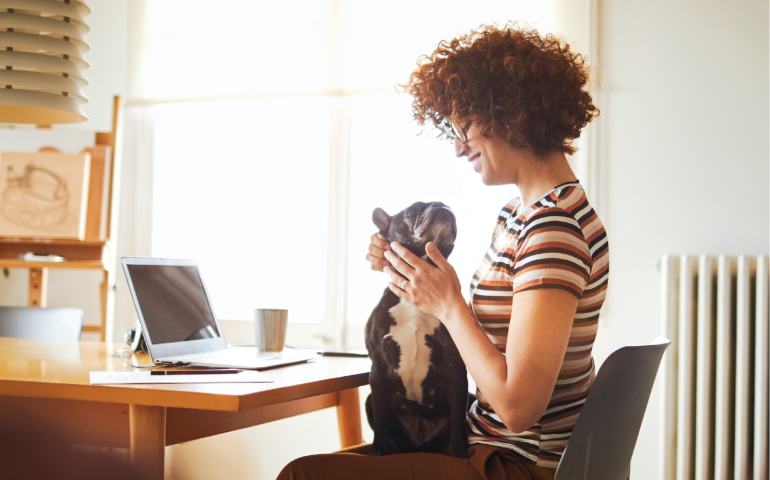 Woman petting dog on her lap